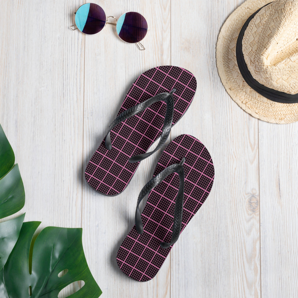 Black and pink check chequered flip-flops with rubber sole and Y-shaped straps, perfect for summer wear.