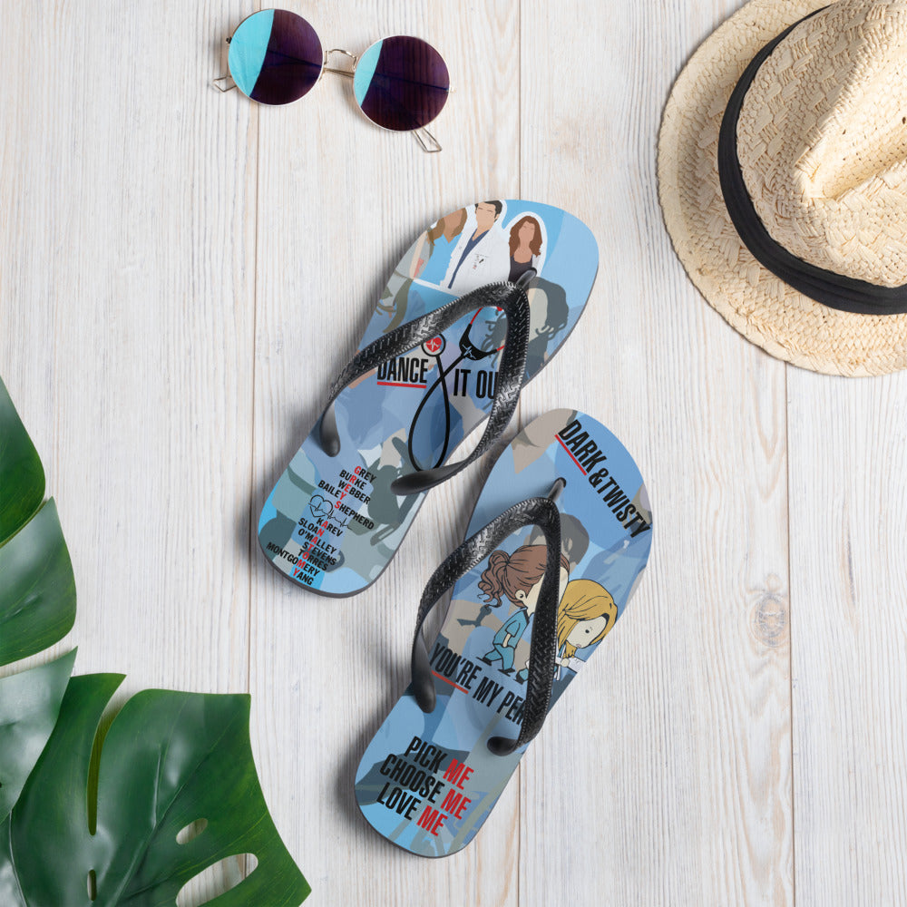 A pair of colorful Greys Flip-Flops with black Y-shaped rubber straps and soft fabric lining, perfect for summer adventures.