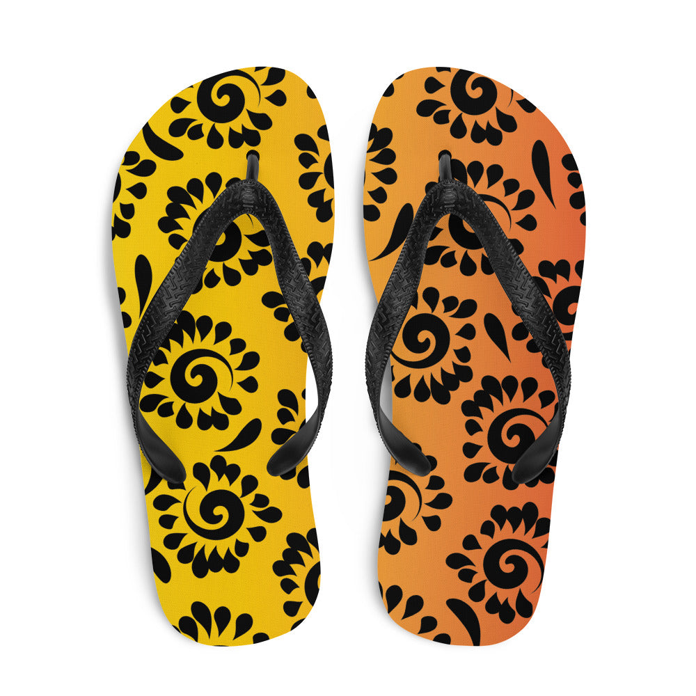 A pair of vibrant orange red black patterned flip-flops with a rubber sole and black Y-shaped straps, perfect for summer wear.