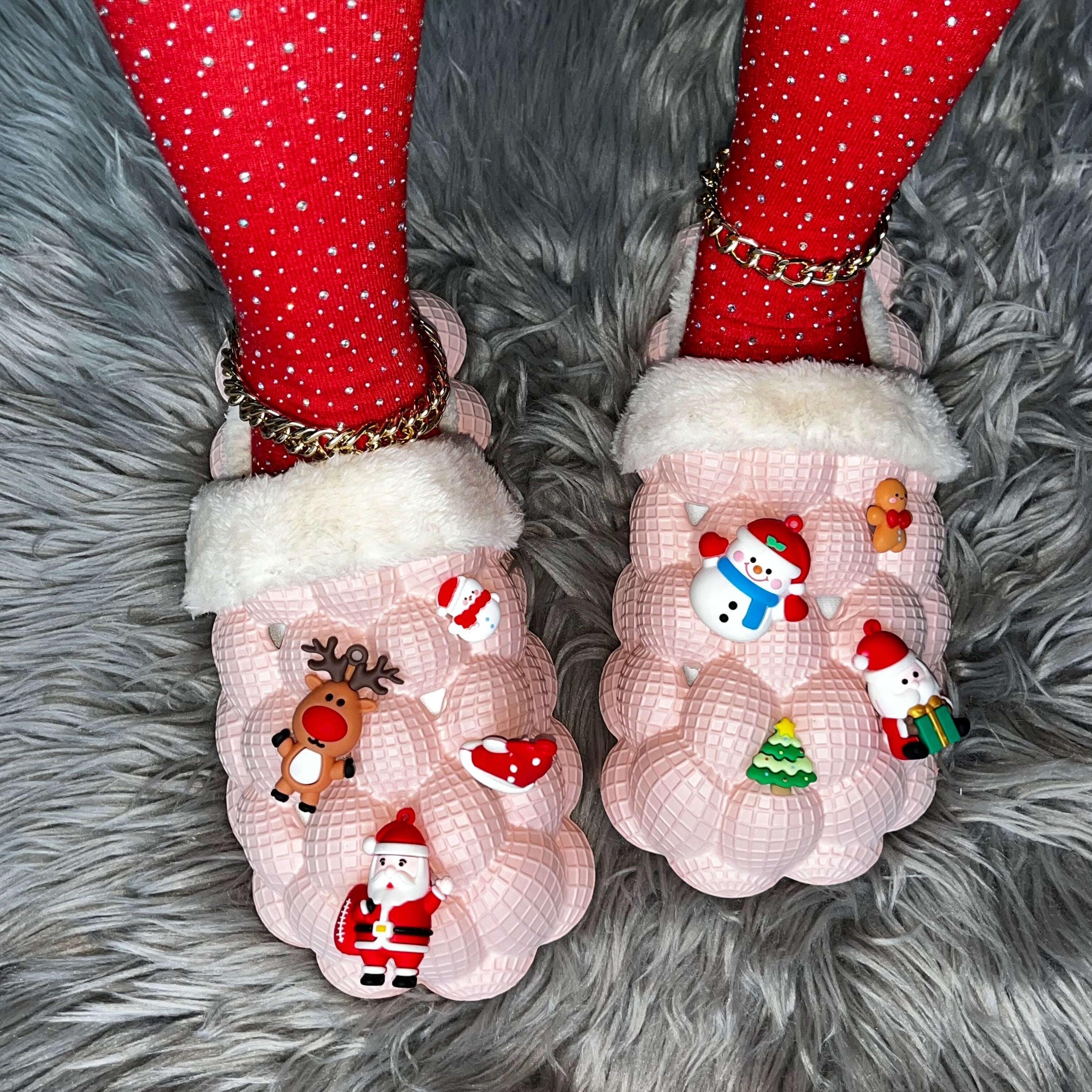 A pair of pink furry house slides with a fluffy texture, designed for indoor comfort and fun, featuring a bubble slipper style perfect for Christmas.