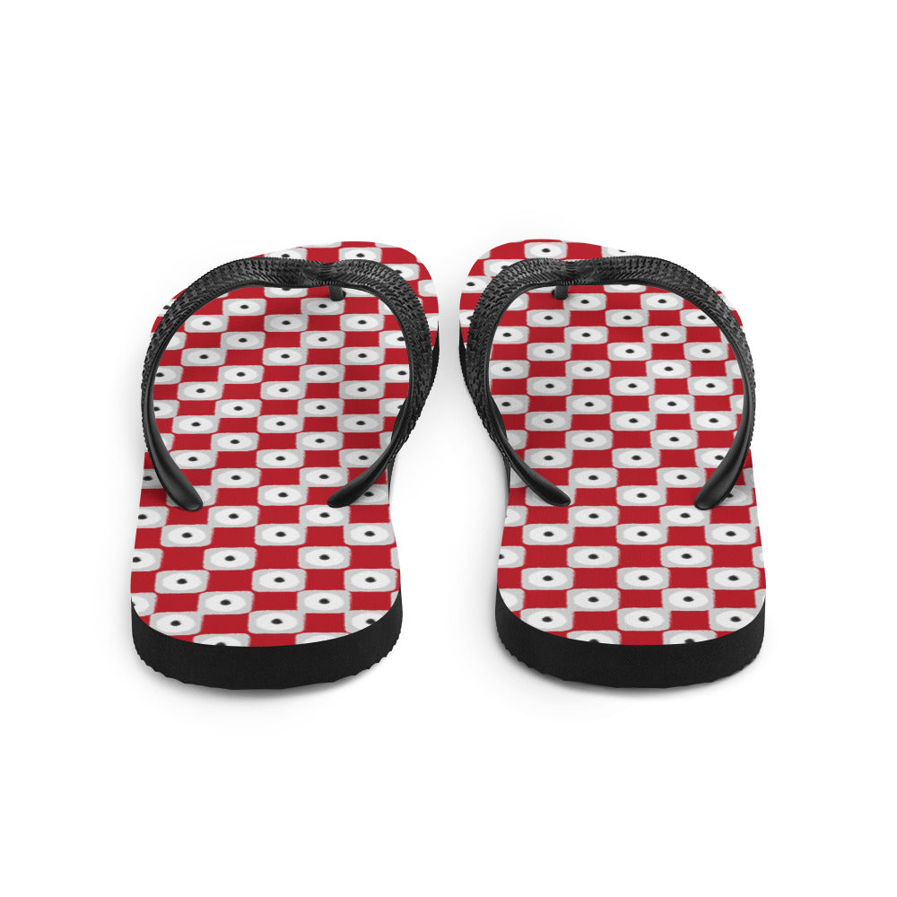 A pair of red chequered pattern flip-flops with black Y-shaped rubber straps and a soft fabric lining, perfect for summer wear.