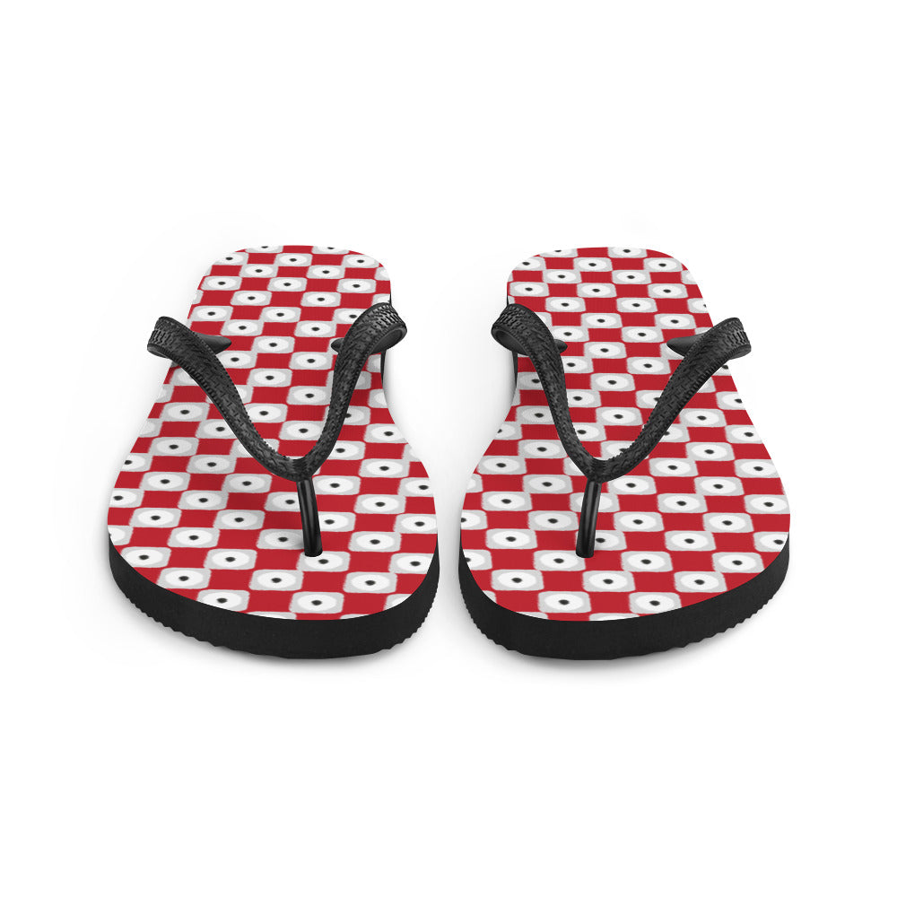 A pair of red chequered pattern flip-flops with black Y-shaped rubber straps and a soft fabric lining, perfect for summer wear.