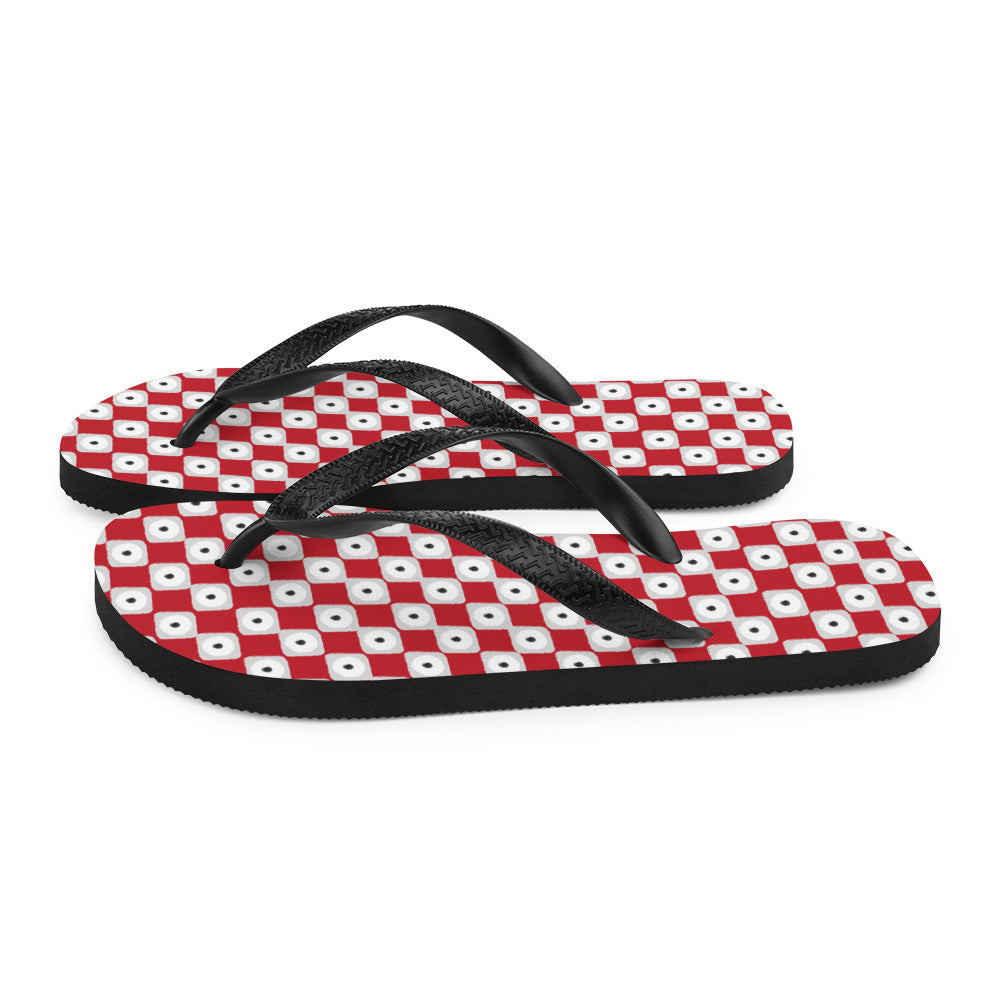 A pair of red chequered pattern flip-flops with black Y-shaped rubber straps and a soft fabric lining, perfect for summer wear.