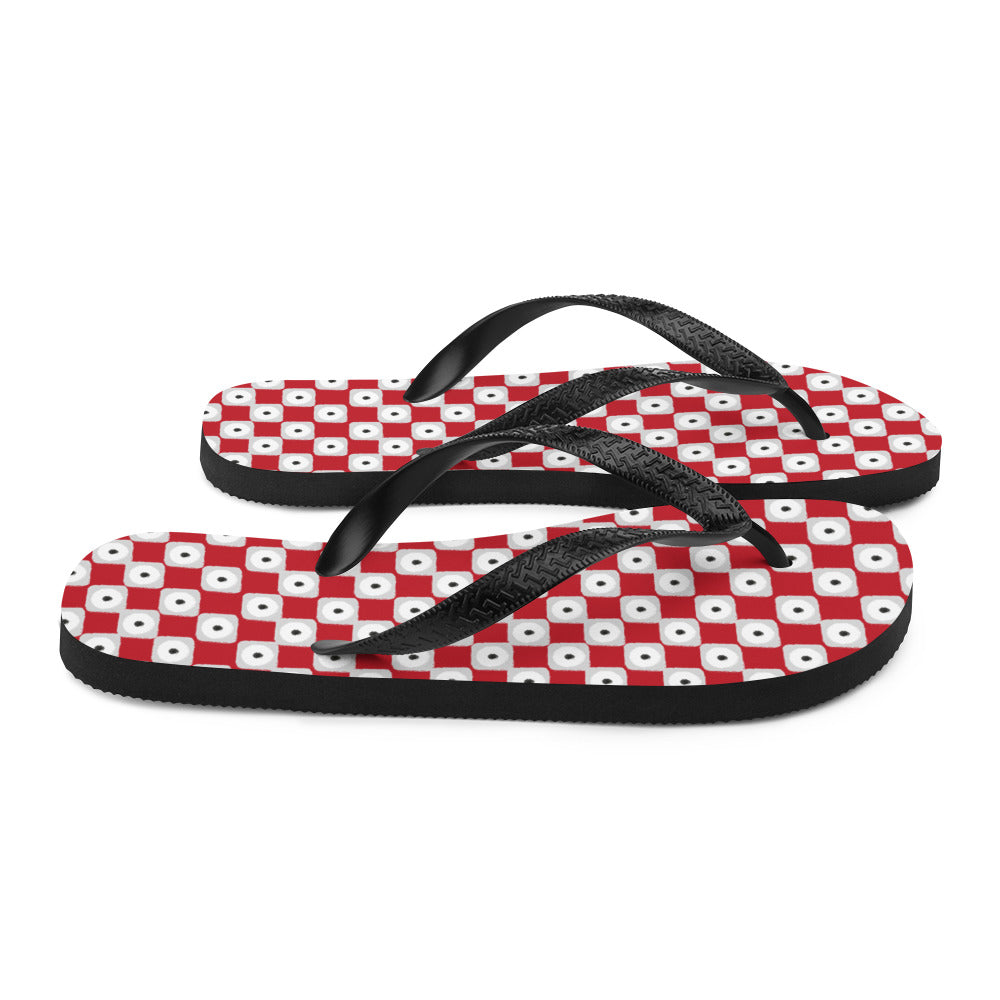 A pair of red chequered pattern flip-flops with black Y-shaped rubber straps and a soft fabric lining, perfect for summer wear.