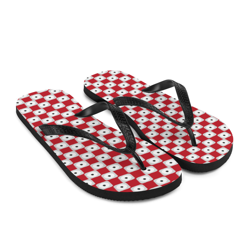 A pair of red chequered pattern flip-flops with black Y-shaped rubber straps and a soft fabric lining, perfect for summer wear.