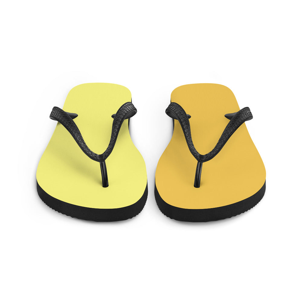 A pair of vibrant yellow and orange flip-flops with black rubber straps, featuring a comfortable rubber sole and soft fabric lining, perfect for summer wear.