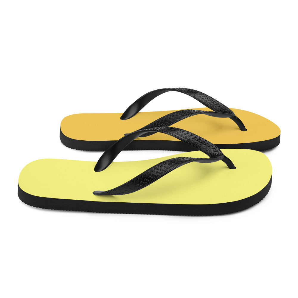 A pair of vibrant yellow and orange flip-flops with black rubber straps, featuring a comfortable rubber sole and soft fabric lining, perfect for summer wear.