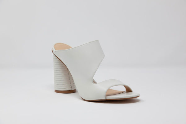 Melanie clogs featuring a white block design, soft leather material, and a stylish cut-out detail on the side with a silver metal accent at the heel.