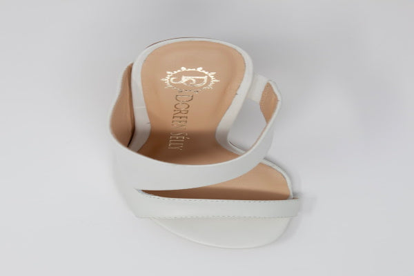 Melanie clogs featuring a white block design, soft leather material, and a stylish cut-out detail on the side with a silver metal accent at the heel.