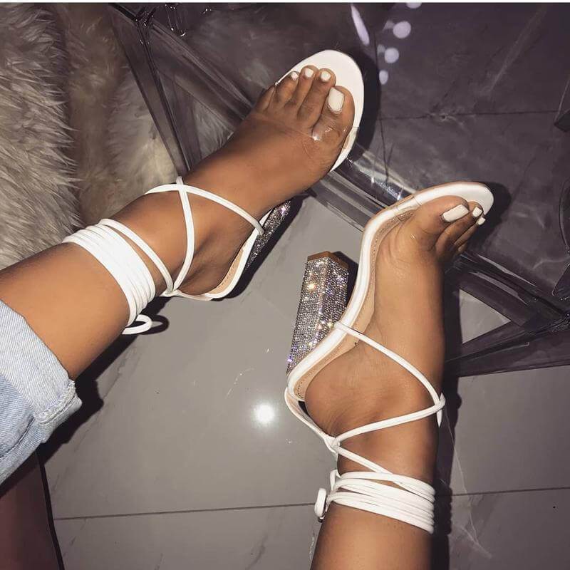 White strappy heels with rhinestones.