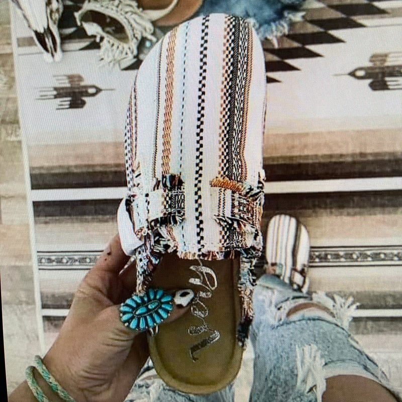 A stylish pair of Women's Vintage Clogs featuring various patterns including Striped, Black, Beige, Leopard, Cows, and Army, showcasing their unique designs.