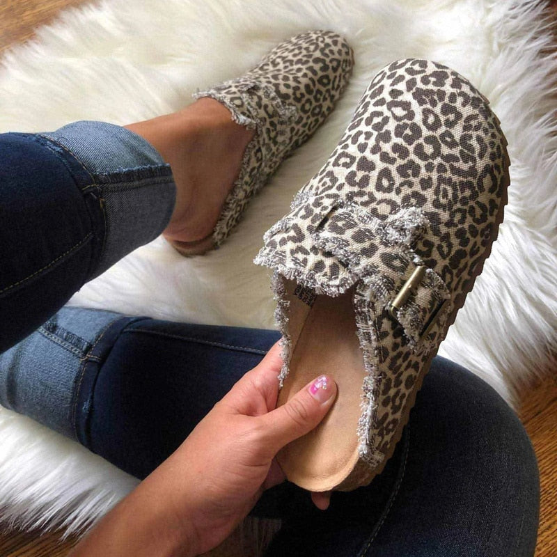 A stylish pair of Women's Vintage Clogs featuring various patterns including Striped, Black, Beige, Leopard, Cows, and Army, showcasing their unique designs.