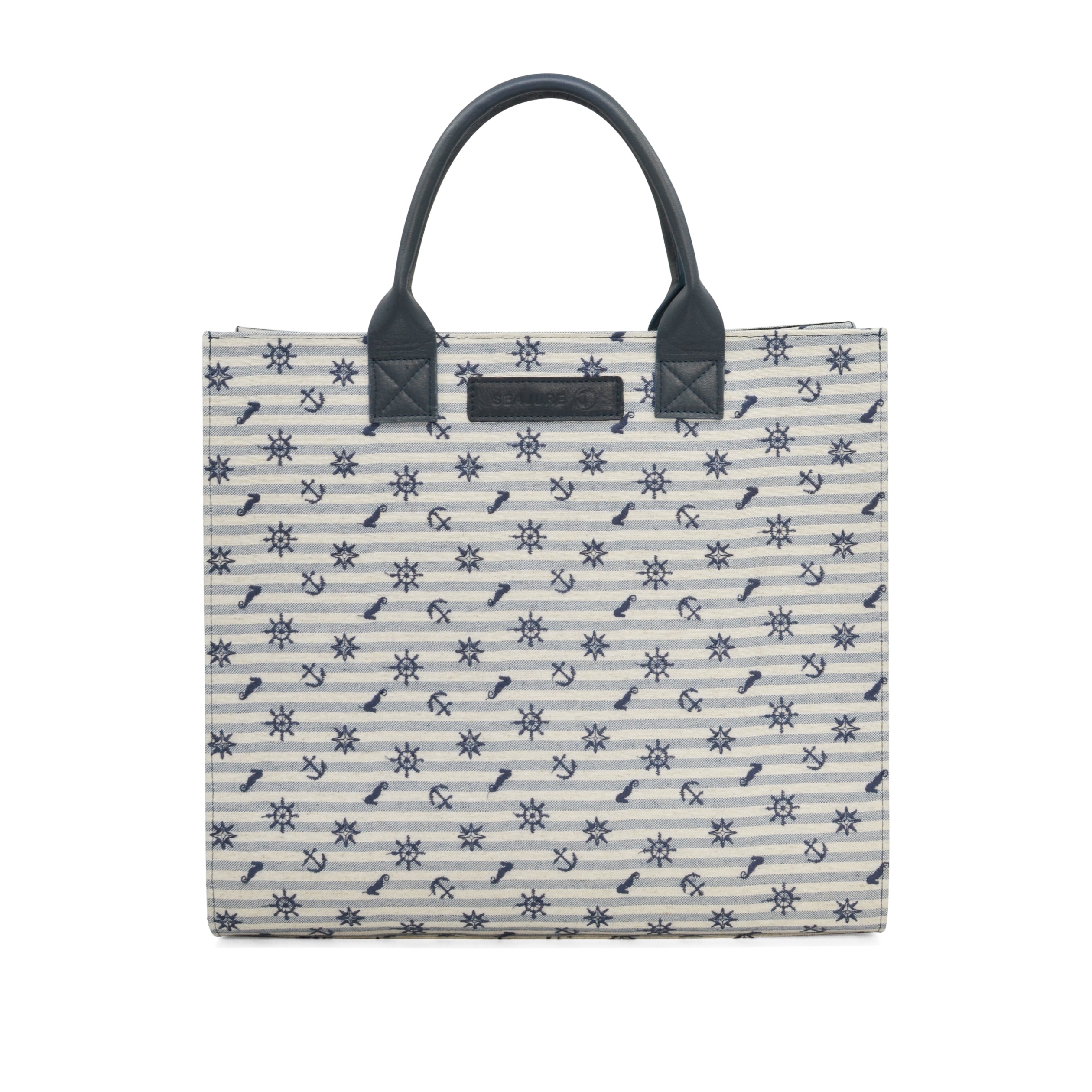 Atol Tote Bag in navy and white linen, featuring embroidered details and premium leather accents, perfect for eco-conscious fashion lovers.