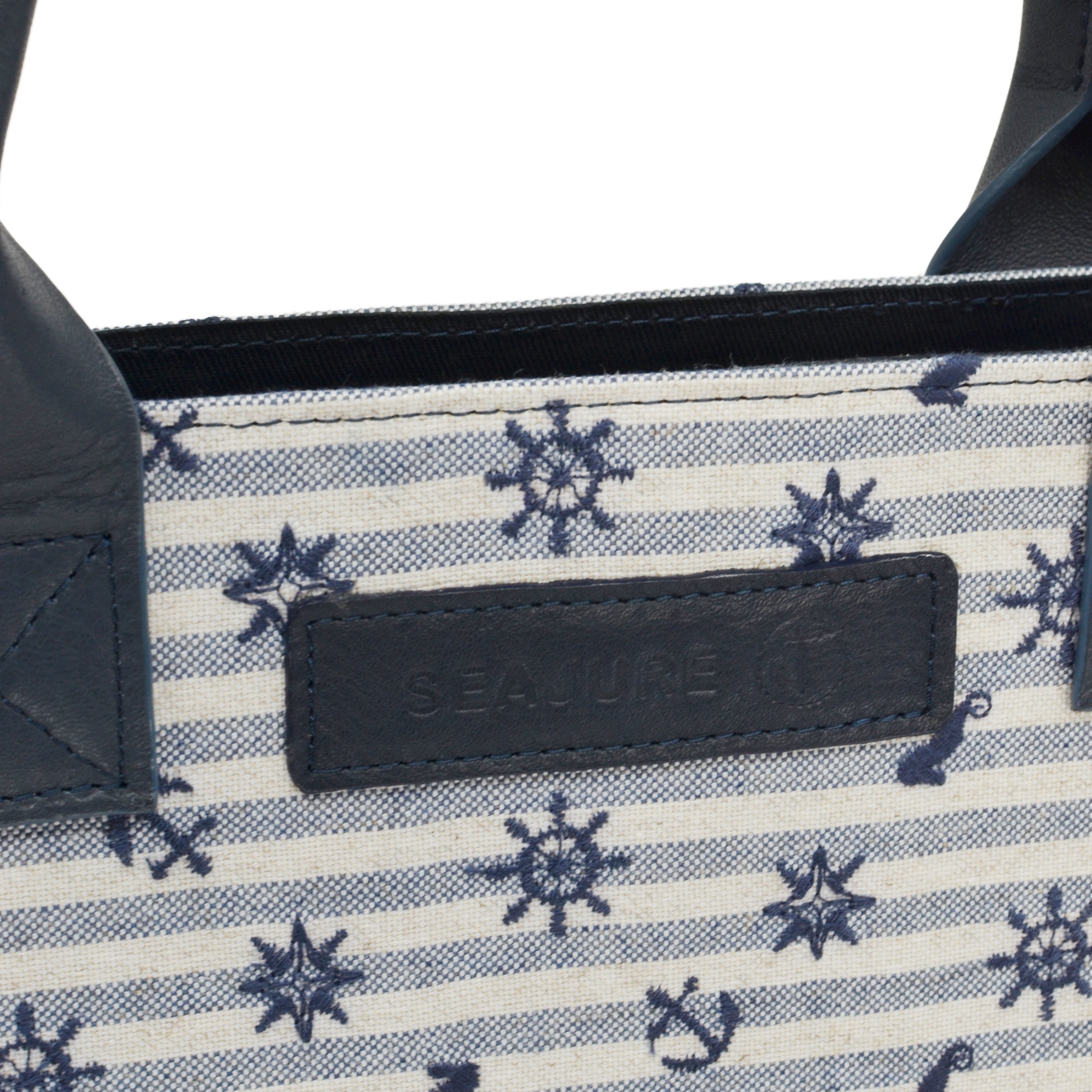 Atol Tote Bag in navy and white linen, featuring embroidered details and premium leather accents, perfect for eco-conscious fashion lovers.