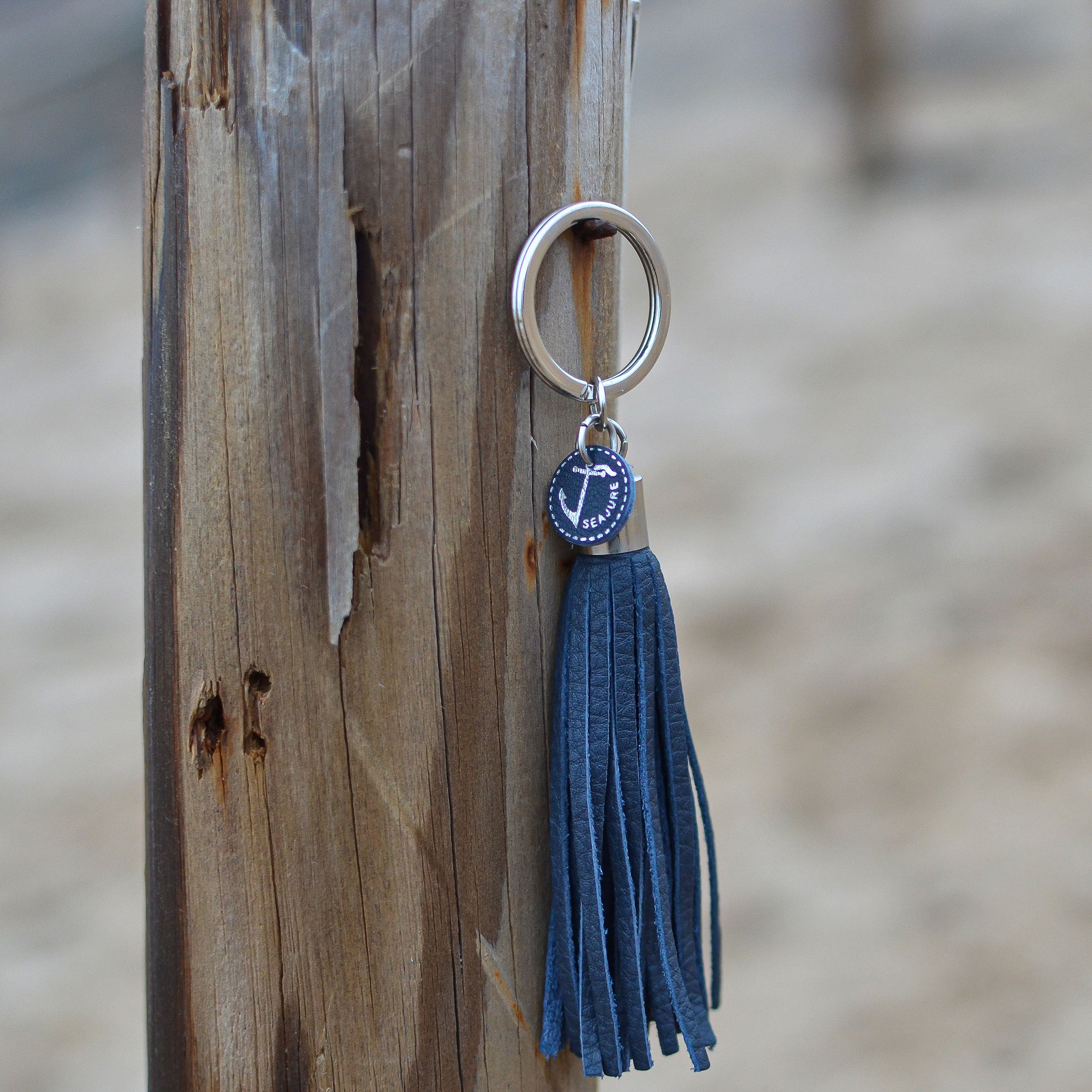 Seajure Leather Tassel Keychain in navy leather with stainless steel hardware, showcasing its elegant design and craftsmanship.