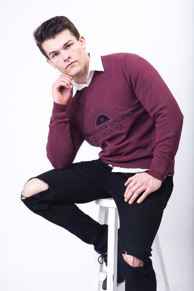 Wakerlook Men's Cotton Blend Burgundy Sweater featuring a classic V-neck, raglan sleeves, and decorative stitching, displayed in a luxury red box.