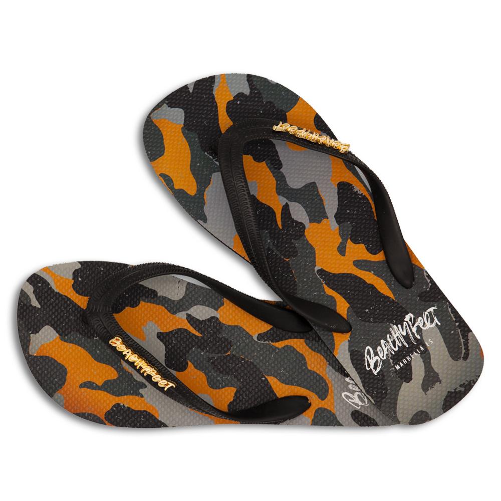 BeachyFeet® Decadente flip flops featuring orange, grey, and black camo print with a black strap and gold emblem.