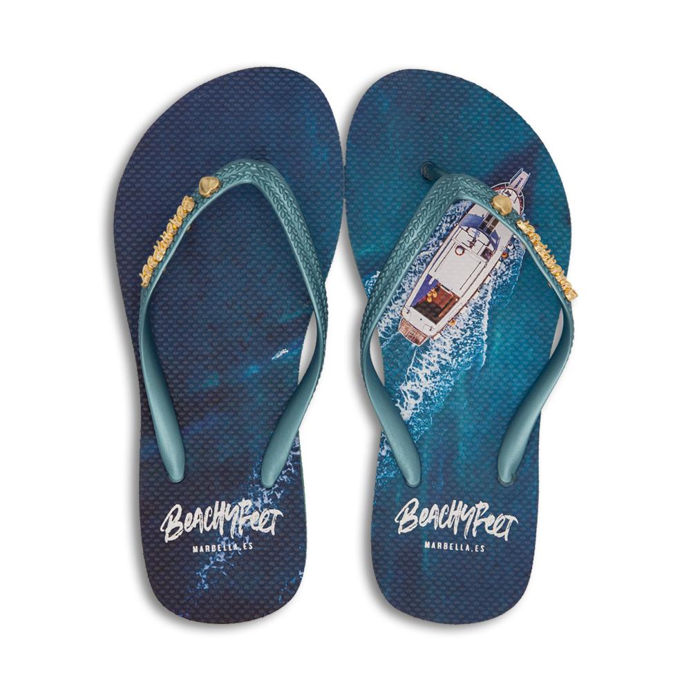 BeachyFeet® - El Oceano flip flops featuring a gold emblem, lightweight design, and textured footbed, perfect for summer activities.