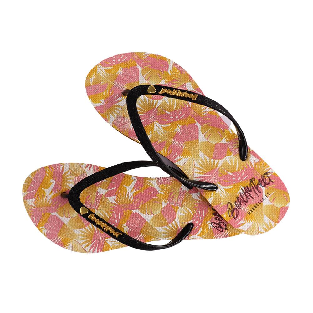 BeachyFeet® - Rosa Tropical flip flops featuring a slimmer strap and gold emblem, perfect for summer wear.