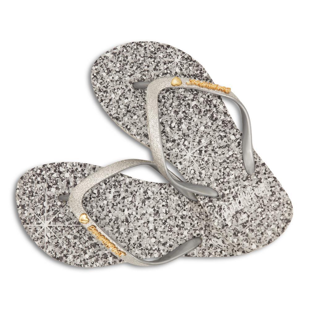 BeachyFeet® Silver Shimmer flip flops featuring a metallic glitter strap and shimmering silver sole, perfect for summer outings.