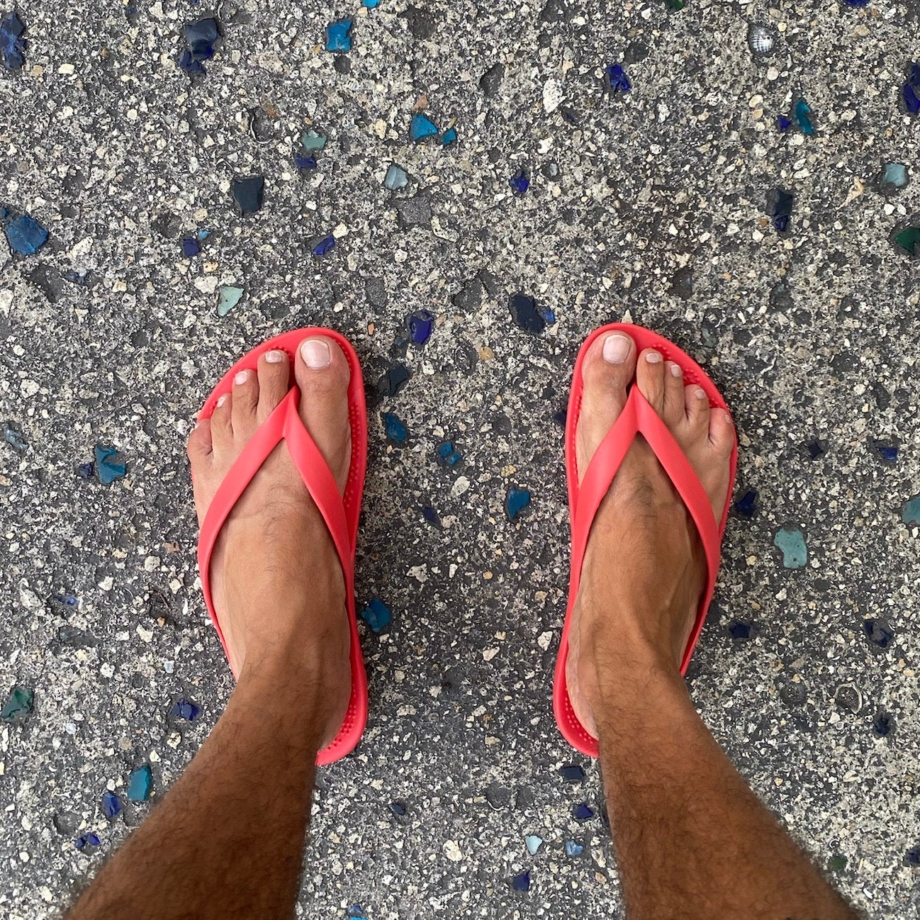 A pair of vibrant Fire Red Flip-Flops by GUDO, showcasing a minimalist design and unique sole pattern, perfect for beach and casual wear.