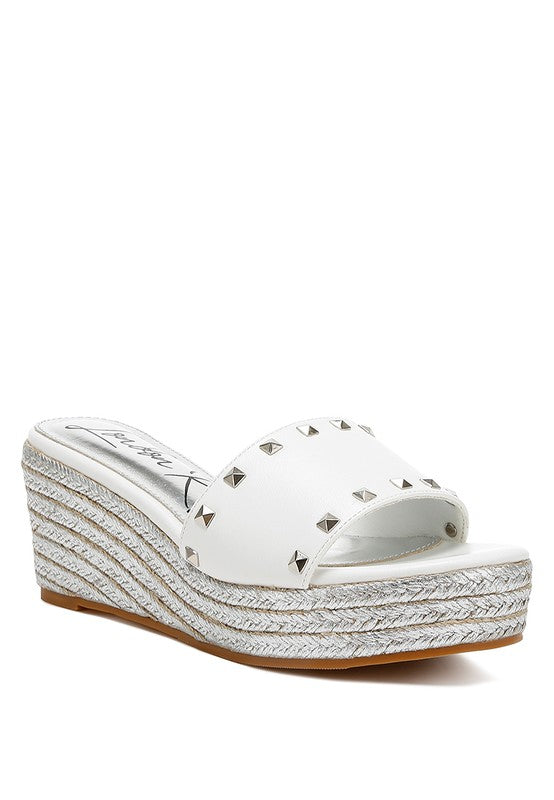 Lilja Slip On Espadrilles featuring metallic accents and stud embellishments on a woven wedge heel.