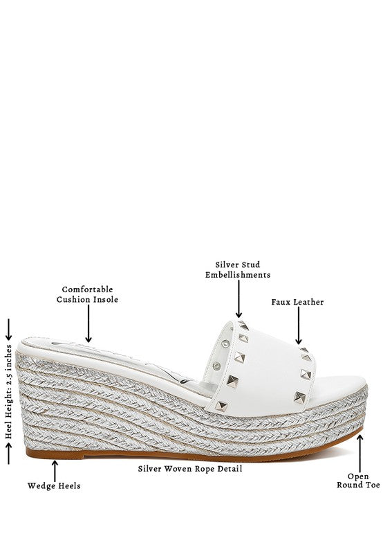 Lilja Slip On Espadrilles featuring metallic accents and stud embellishments on a woven wedge heel.