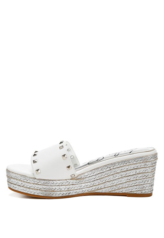 Lilja Slip On Espadrilles featuring metallic accents and stud embellishments on a woven wedge heel.