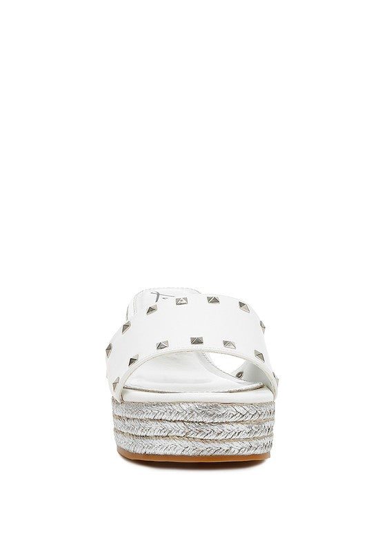 Lilja Slip On Espadrilles featuring metallic accents and stud embellishments on a woven wedge heel.