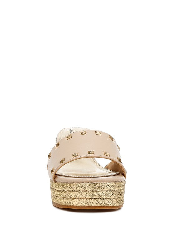 Lilja Slip On Espadrilles featuring metallic accents and stud embellishments on a woven wedge heel.