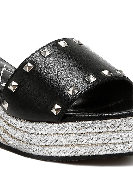 Lilja Slip On Espadrilles featuring metallic accents and stud embellishments on a woven wedge heel.