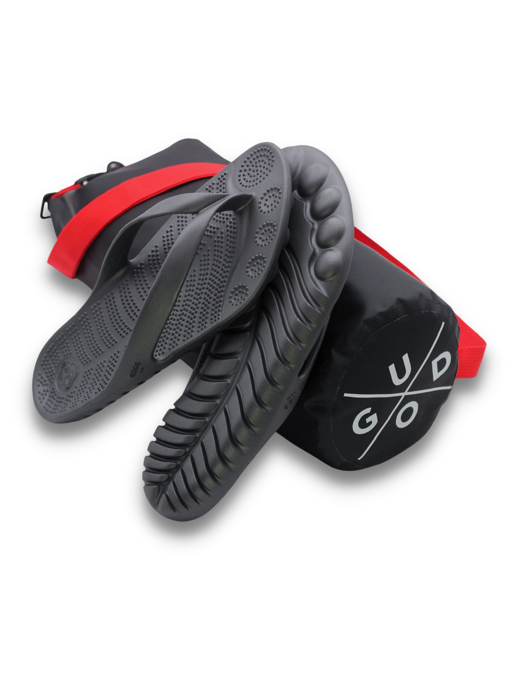 GUDO Night Platinum Flip-Flops displayed with a waterproof mini drybag, showcasing their minimalist design and eco-friendly materials.