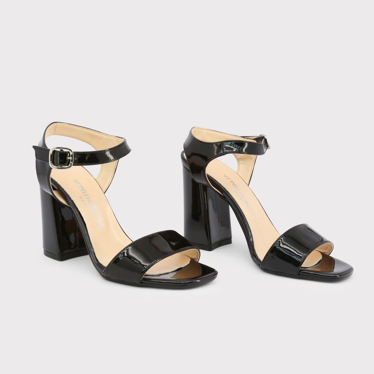 A pair of elegant patent leather high heel sandals featuring a 4-inch heel and ankle strap buckle, perfect for stylish occasions.