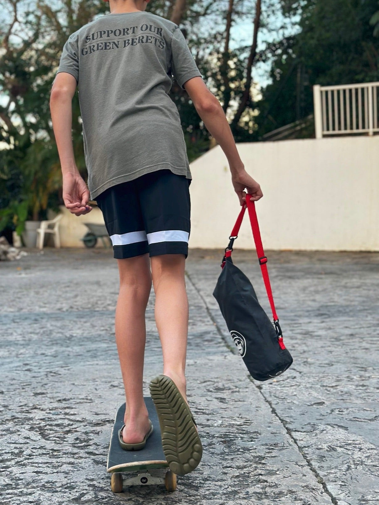 Seaweed Green Flip-Flops with a waterproof mini drybag, showcasing a minimalist design and eco-friendly materials.