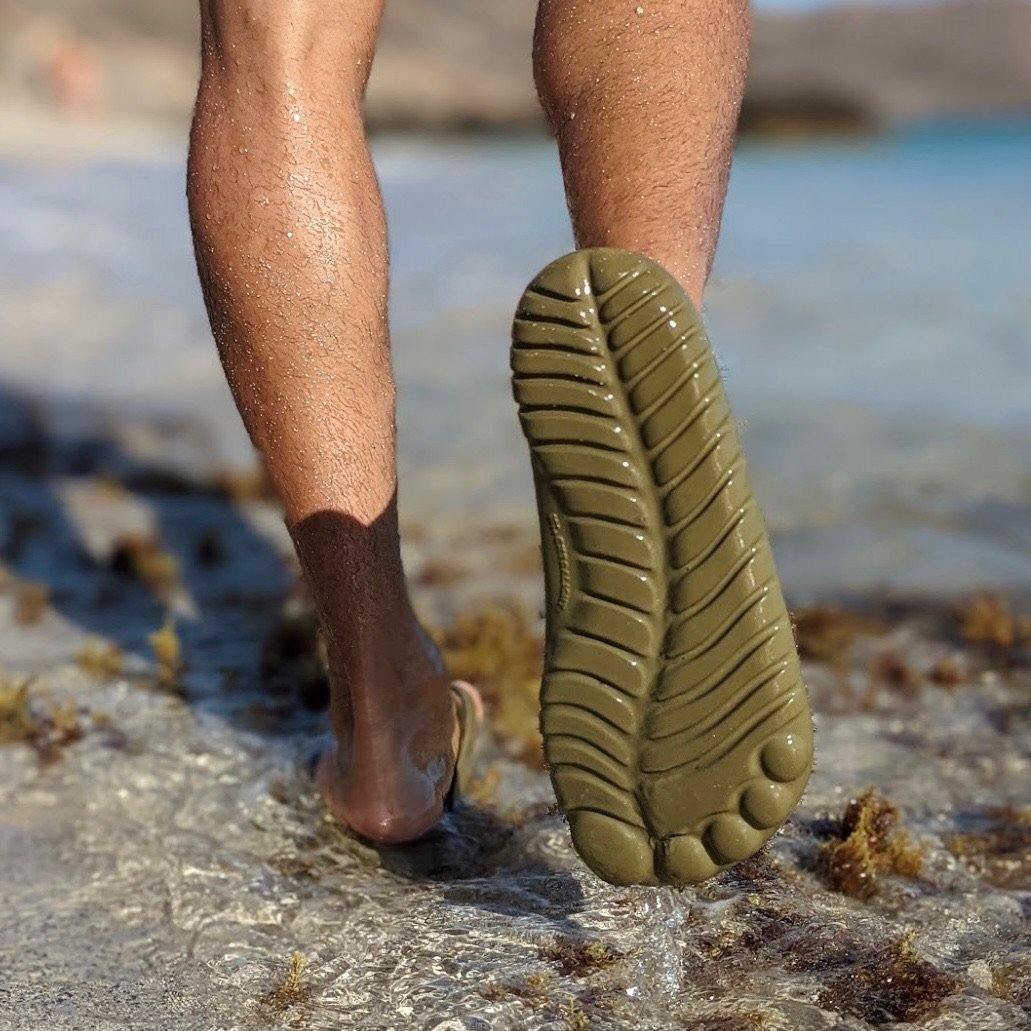 Seaweed Green Flip-Flops with a waterproof mini drybag, showcasing a minimalist design and eco-friendly materials.