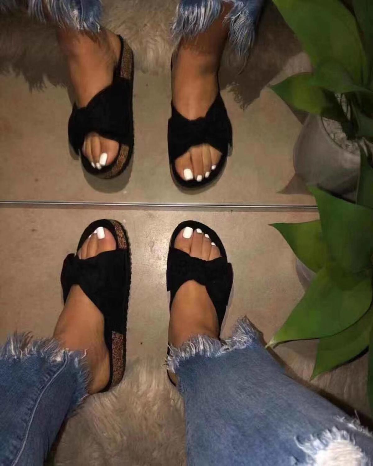 A pair of black Women Slides featuring a comfy bow design, ideal for casual summer wear.