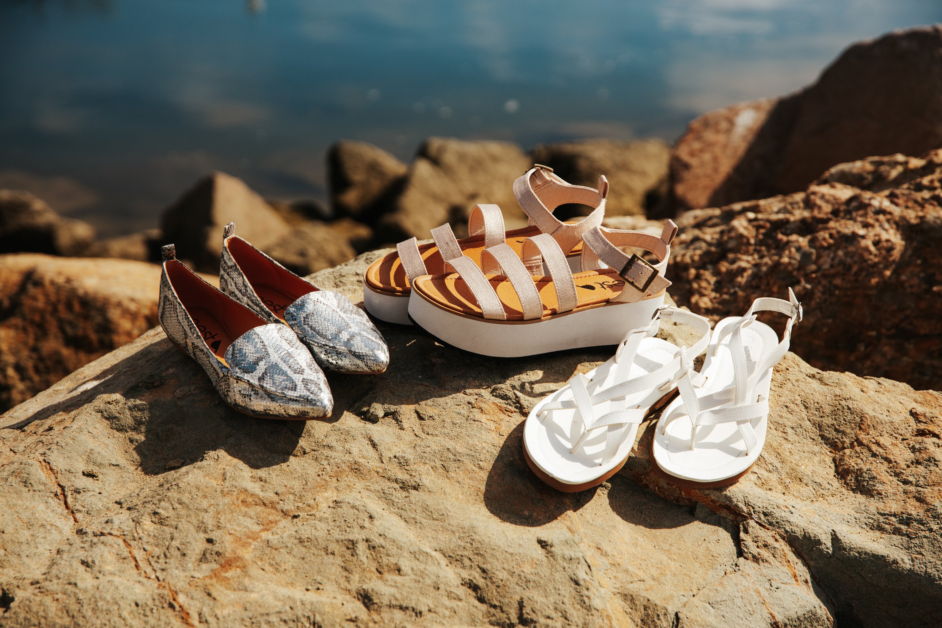 Stylish Women's Sandal Bernardo in white with criss-cross straps and adjustable metal closure, perfect for summer outfits.