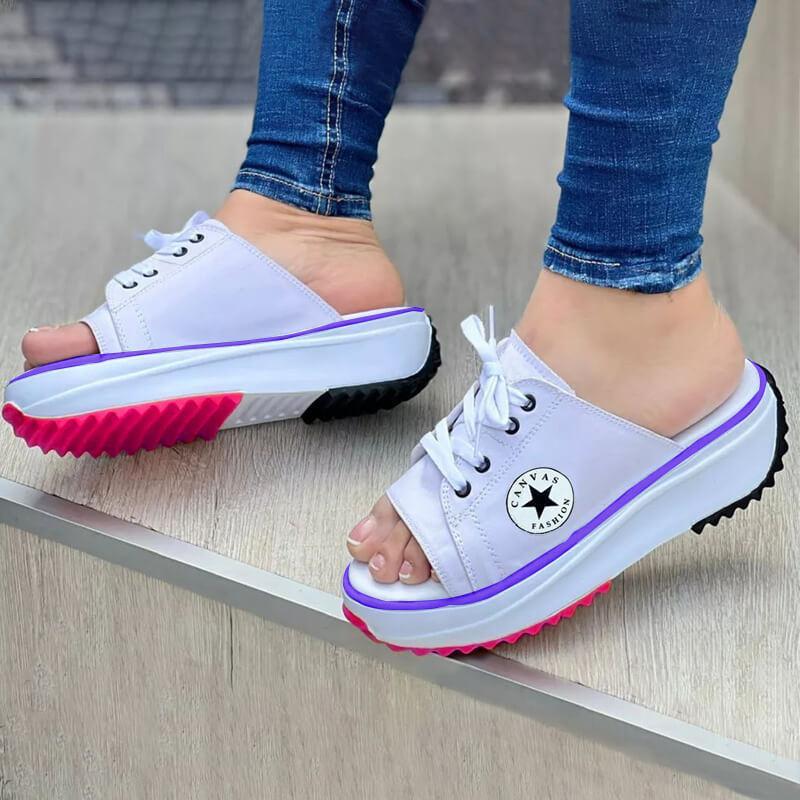 A pair of 2022 Casual Canvas Thick-soled Lace-up Women's Sandals Slippers featuring a stylish lace-up design and thick soles for comfort.