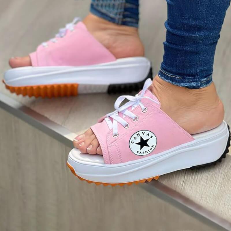 A pair of 2022 Casual Canvas Thick-soled Lace-up Women's Sandals Slippers featuring a stylish lace-up design and thick soles for comfort.