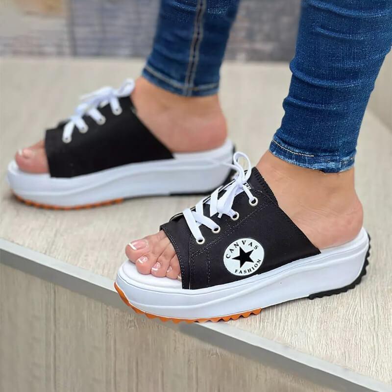 A pair of 2022 Casual Canvas Thick-soled Lace-up Women's Sandals Slippers featuring a stylish lace-up design and thick soles for comfort.