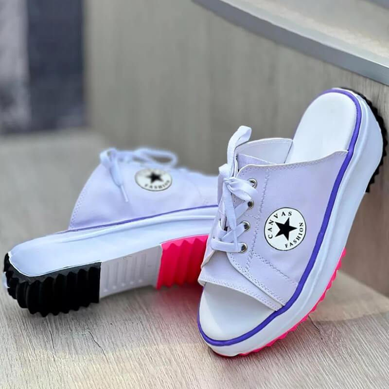 A pair of 2022 Casual Canvas Thick-soled Lace-up Women's Sandals Slippers featuring a stylish lace-up design and thick soles for comfort.