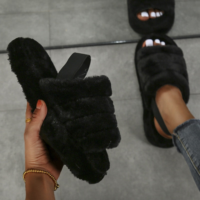 A pair of stylish black women heel slides made from elastic cloth with a thick sole, designed for comfort and modern fashion.