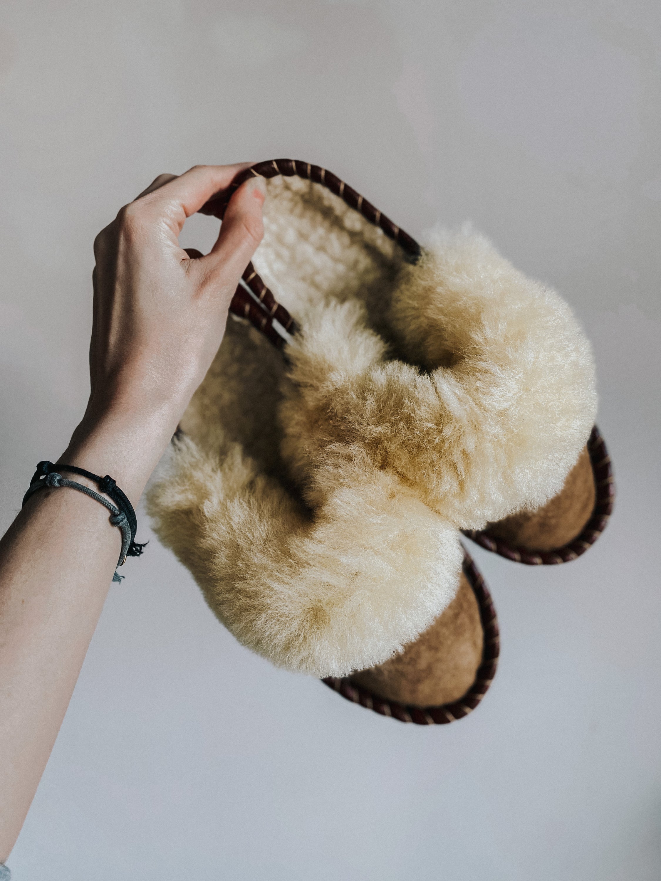 Burnt Caramel Slip Ons featuring brown leather and natural fur, showcasing a cozy and stylish design.