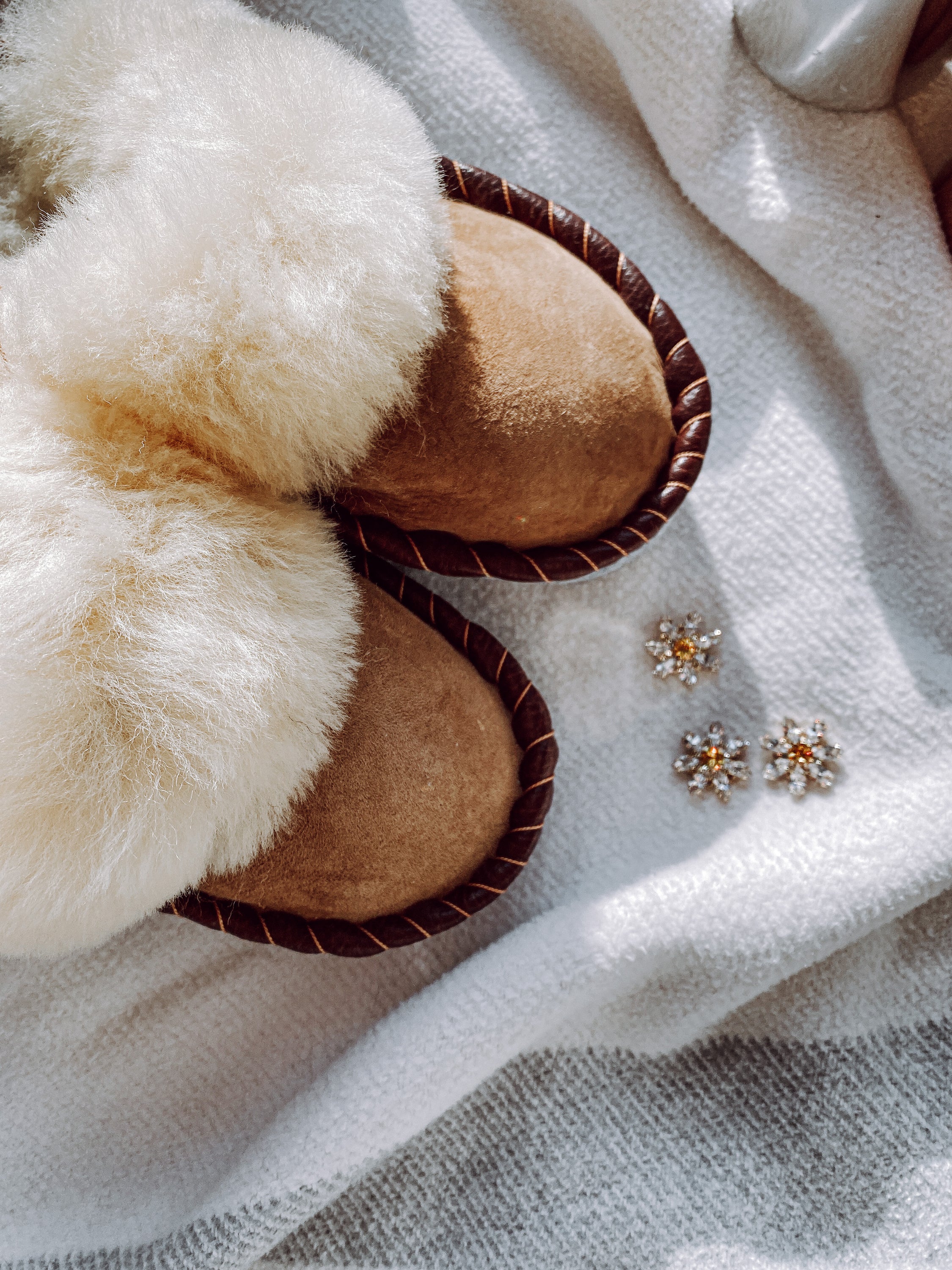 Burnt Caramel Slip Ons featuring brown leather and natural fur, showcasing a cozy and stylish design.