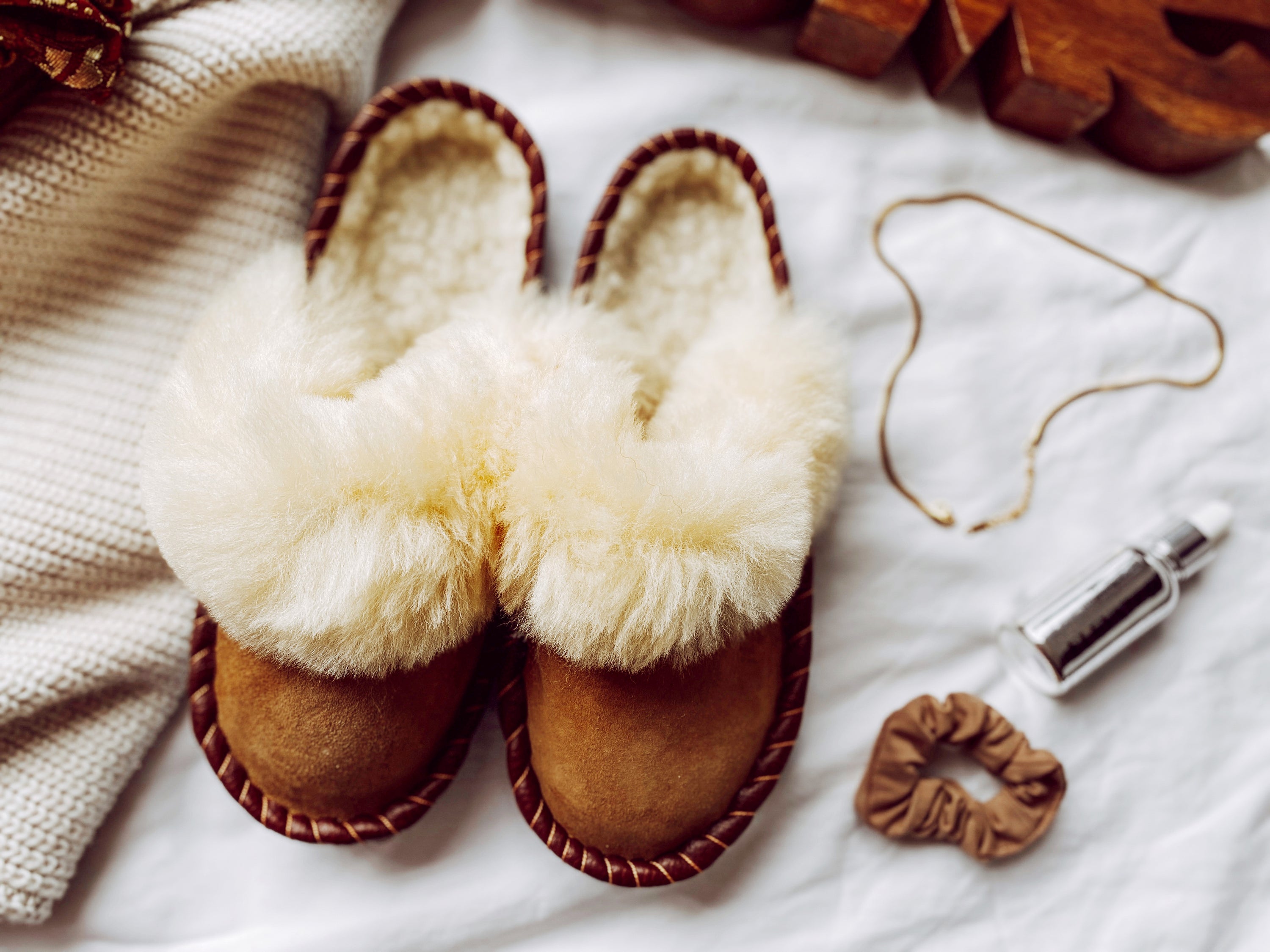 Burnt Caramel Slip Ons featuring brown leather and natural fur, showcasing a cozy and stylish design.