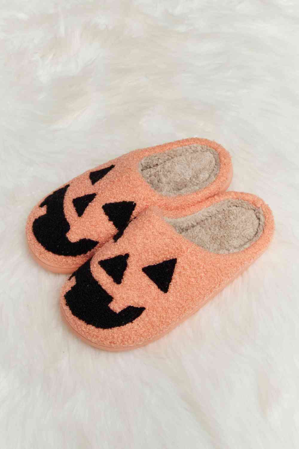 A pair of Comfy Cozy Plush Slide Slippers featuring a soft faux fur top and a durable rubber sole, perfect for indoor and outdoor use.