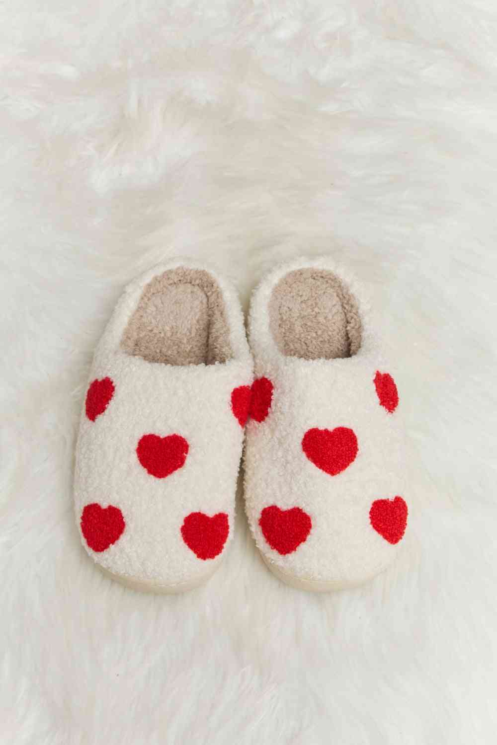 A pair of Comfy Cozy Plush Slide Slippers featuring a soft faux fur top and a durable rubber sole, perfect for indoor and outdoor use.