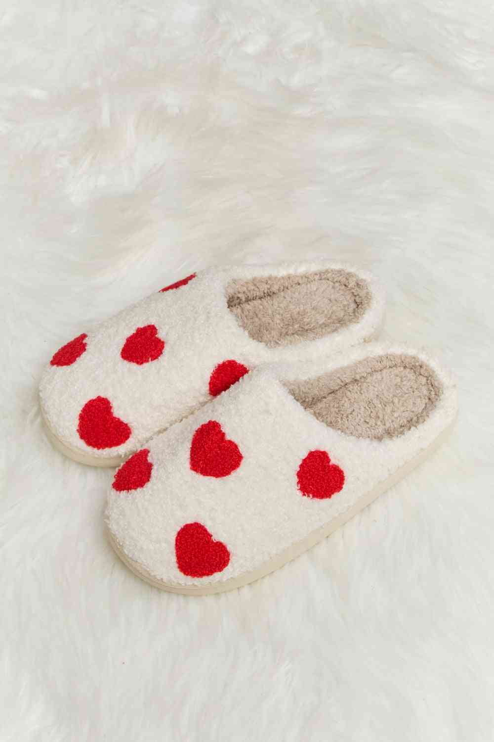 A pair of Comfy Cozy Plush Slide Slippers featuring a soft faux fur top and a durable rubber sole, perfect for indoor and outdoor use.