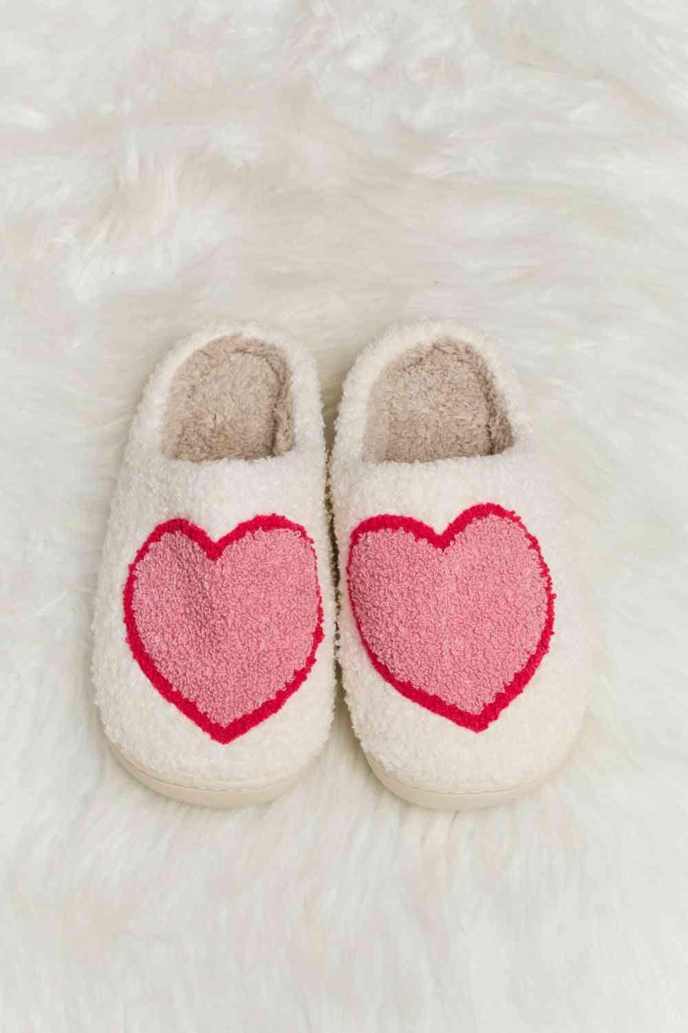 A pair of Comfy Cozy Plush Slide Slippers featuring a soft faux fur top and a durable rubber sole, perfect for indoor and outdoor use.