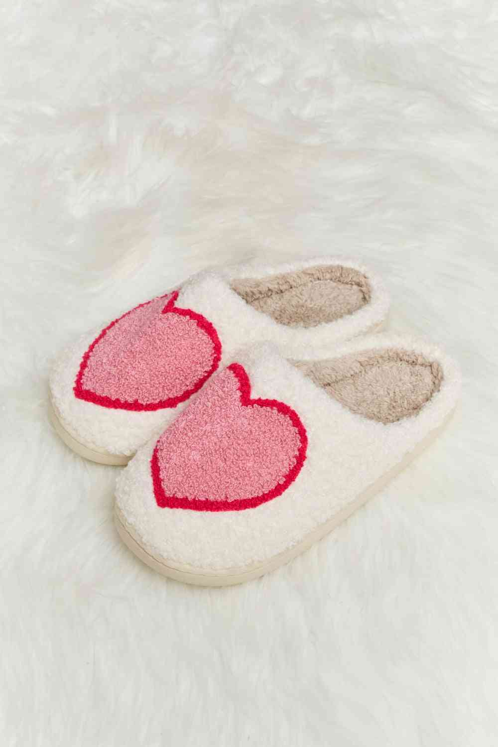 A pair of Comfy Cozy Plush Slide Slippers featuring a soft faux fur top and a durable rubber sole, perfect for indoor and outdoor use.